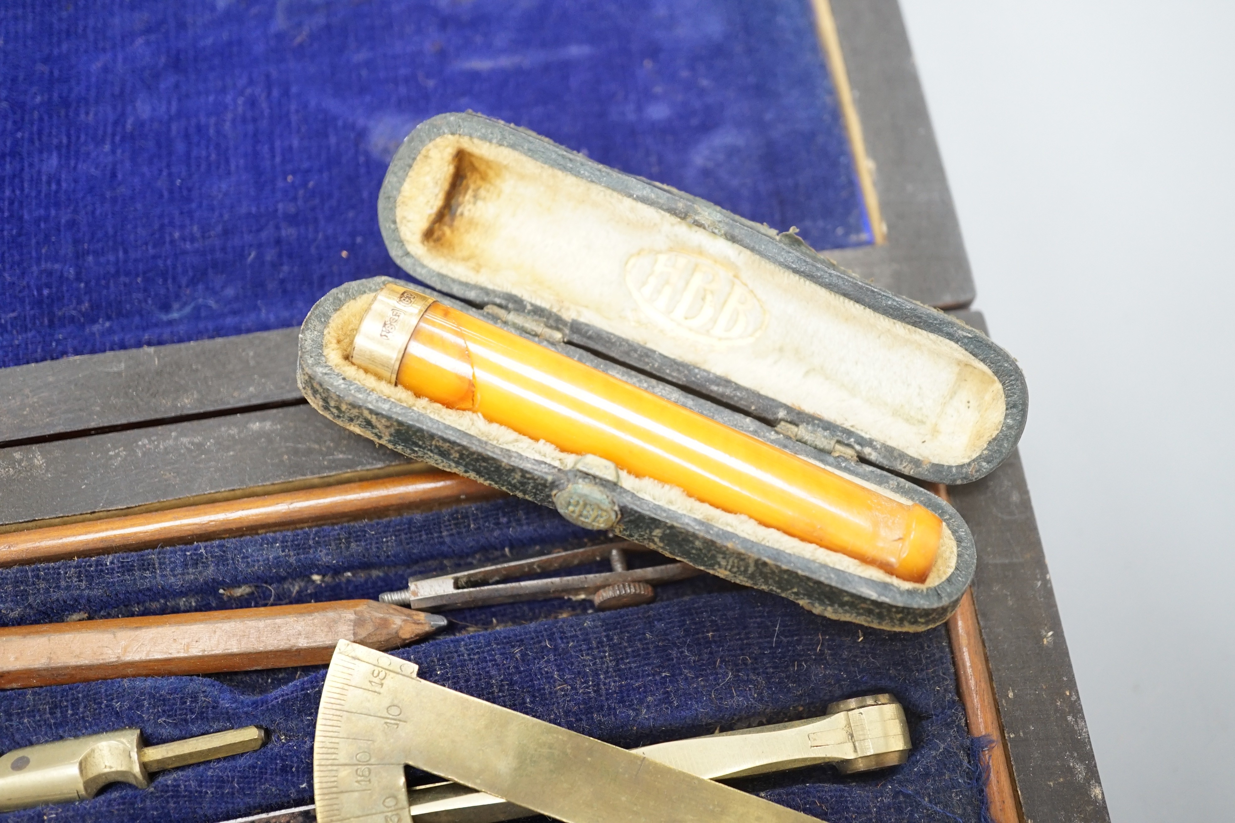 A Victorian draughtsman's set, a gold mounted amber cigar holder and a pocket knife, bone handle